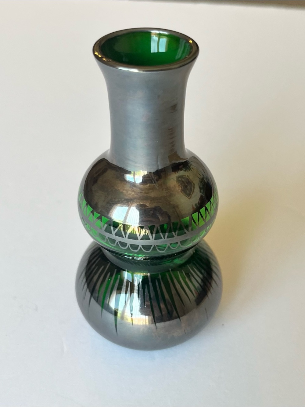 Vintage green glass bud vase with silver overlay. Approximately 4” tall.